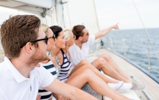 Vacation Travel Sea Friendship People Concept Smiling Friends Sitting Yacht Deck Pointing Finger